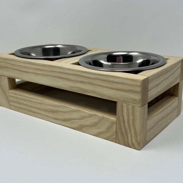 Natural wood elevated dog food and water dish to help dog eat and drink easier